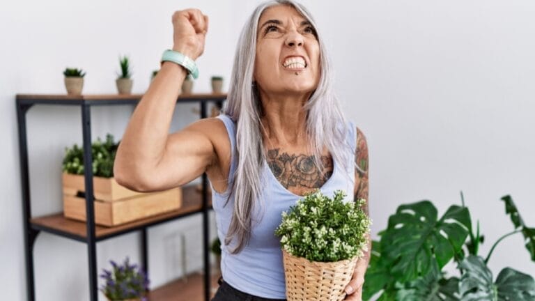 Beware of These 15 Plants—They'll Quickly Become Your Worst Enemies 6 Beware of These 15 Plants—They'll Quickly Become Your Worst Enemies - woman holding green plant ss2221482603