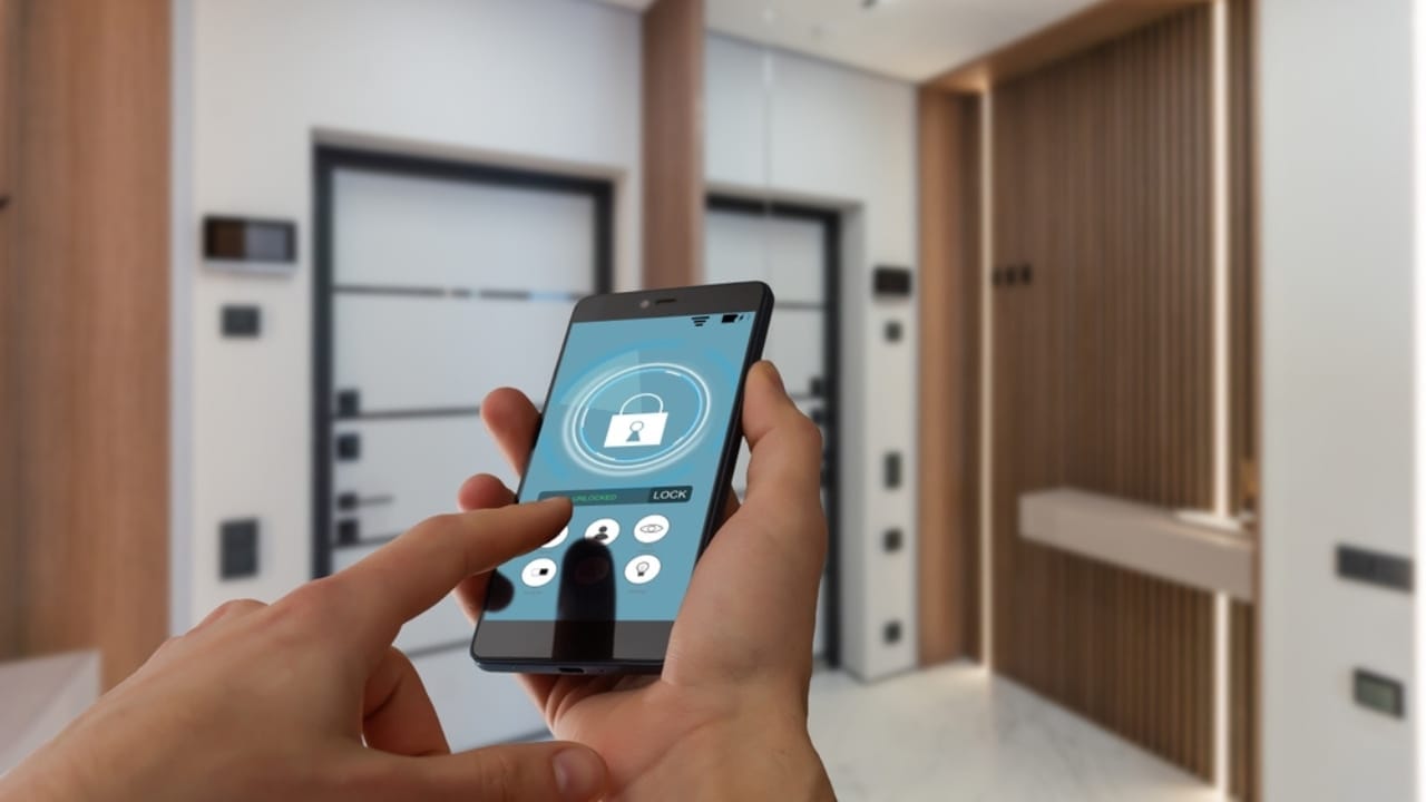 Turn Your Dusty Old Smartphone into a Home Security System 3 Turn Your Dusty Old Smartphone into a Home Security System - woman holding phone with security application on screen ss2485687075