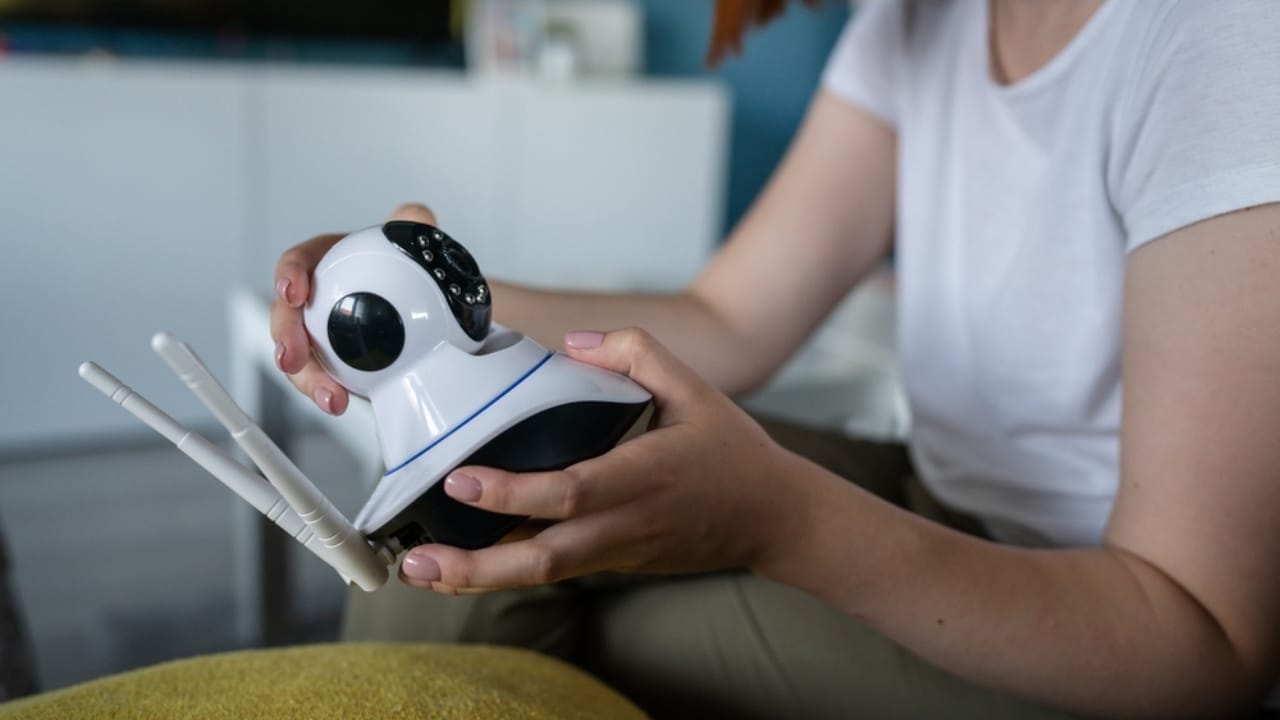 Turn Your Dusty Old Smartphone into a Home Security System 4 Turn Your Dusty Old Smartphone into a Home Security System - woman setting up security camera ss2218396897