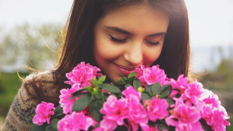 15 Fragrant Plants to Keep Your Garden Blooming from Spring to Fall 7 15 Fragrant Plants to Keep Your Garden Blooming from Spring to Fall - woman smelling flower ss190921283