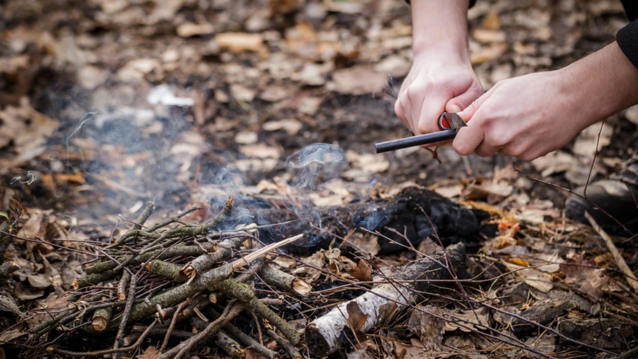 Stop Tossing Those Pistachio Shells... Here's What to Do Instead - A man makes a fire with a flint dp252047614