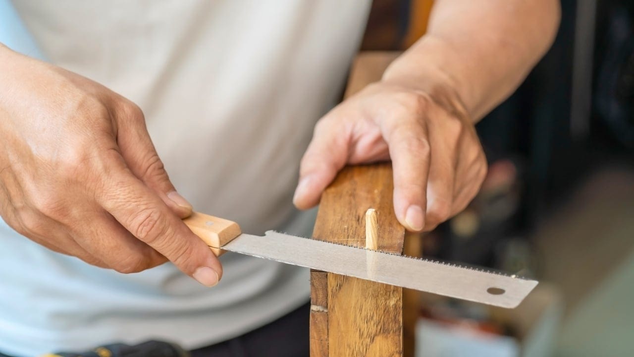 10 Must-Have Skills for an Off-Grid, Electricity-Free Lifestyle 7 10 Must-Have Skills for an Off-Grid, Electricity-Free Lifestyle - Carpenter using Japanese saw or pull saw ss2263800465 degm