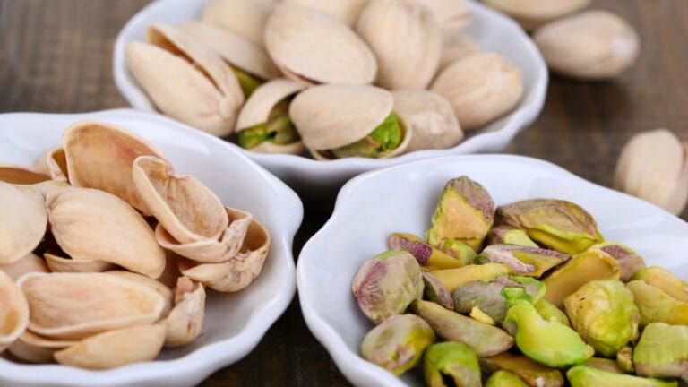 Stop Tossing Those Pistachio Shells... Here's What to Do Instead - Pistachio nuts in small bowls dp40034481