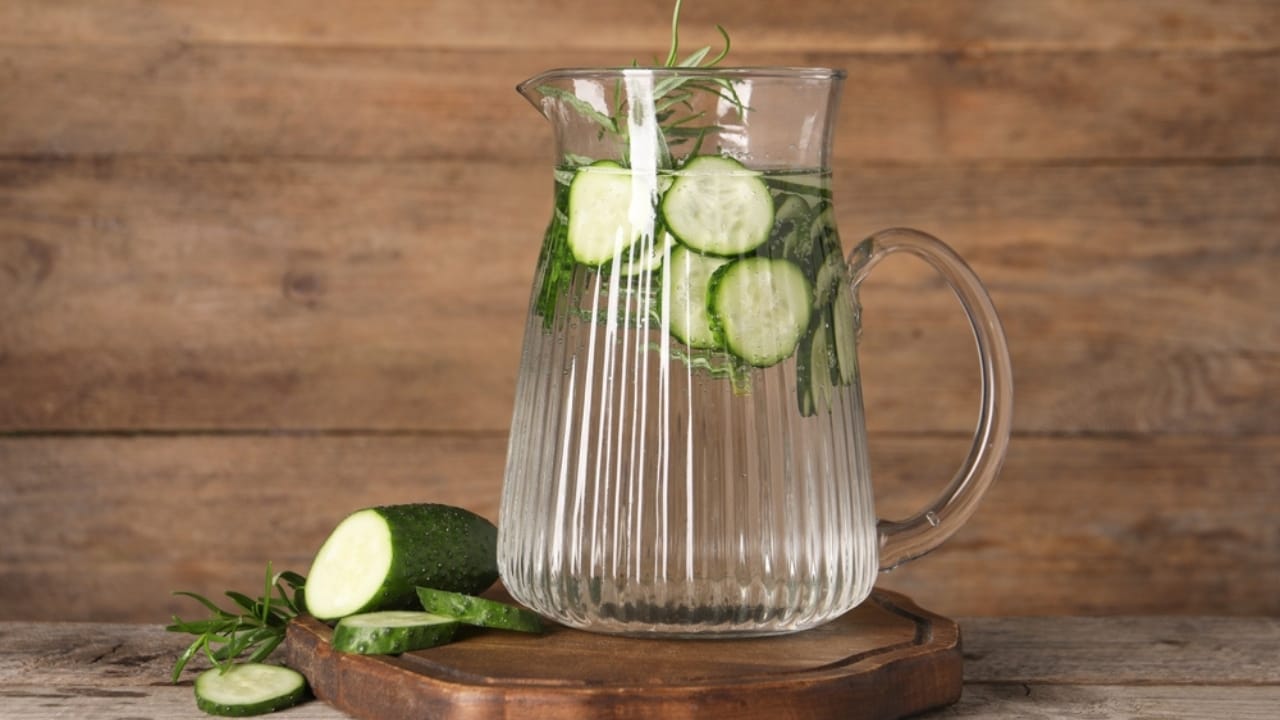 12 Reasons to Add Cucumber Water to Your Wellness Routine 8 12 Reasons to Add Cucumber Water to Your Wellness Routine - Refreshing cucumber water with rosemary in jug ss2480248713