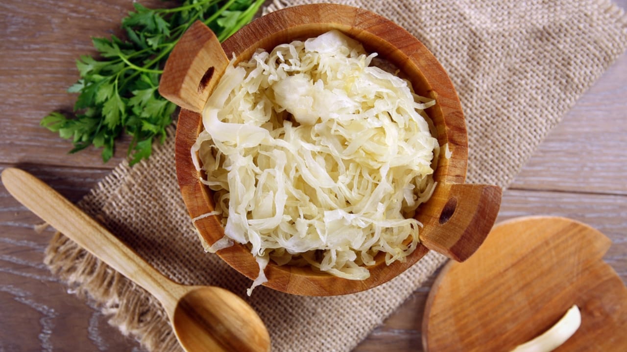 15 Wallet-Friendly Sources to Get Your Probiotics without Supplements - Sauerkraut in a wooden barrel dp54174701