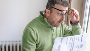 14 Energy-Hungry Devices Hiking Your Electric Bill 1 14 Energy-Hungry Devices Hiking Your Electric Bill - Shocked man reading some bills energy expenses ss2124450632