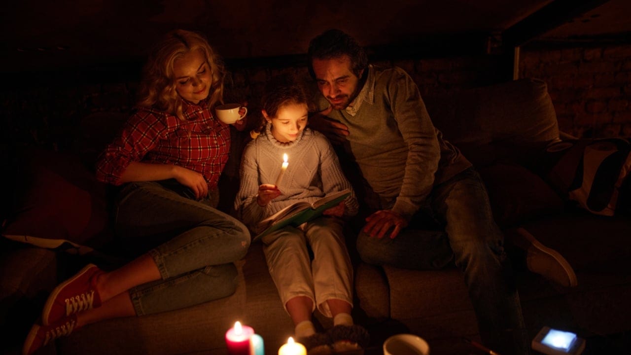 Prepping for Power Outages: 30 Important Steps to Stay Safe & Comfortable 23 Prepping for Power Outages: 30 Important Steps to Stay Safe & Comfortable - family sitting in sofa power outage bonding dp638434362