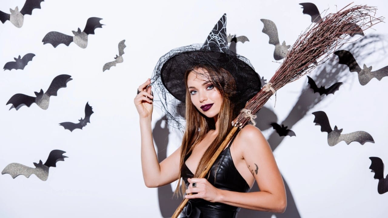Craft Your Own Magical Halloween Witches' Broom: 2 Free DIY Methods - girl witch holding broom dp310715646