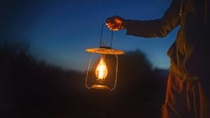 10 Must-Have Skills for an Off-Grid, Electricity-Free Lifestyle 1 10 Must-Have Skills for an Off-Grid, Electricity-Free Lifestyle - man holding old lamp with candle ss530091271