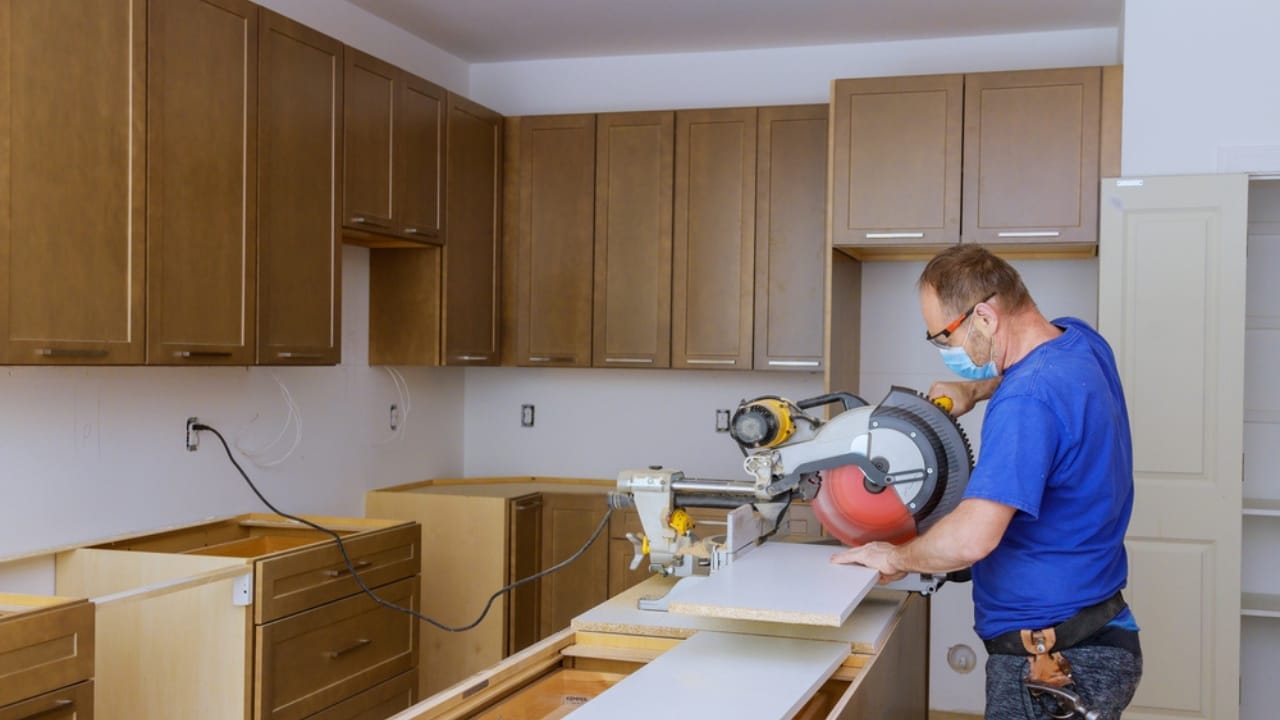 Maximize Your Garage Space with These 18 Simple DIY Organization Projects - man making cabinet furniture ss1764428258