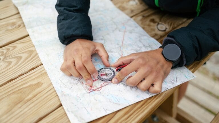 21 Lost Pioneer Skills That Few People Know Today - man using compass and map ss2340048267
