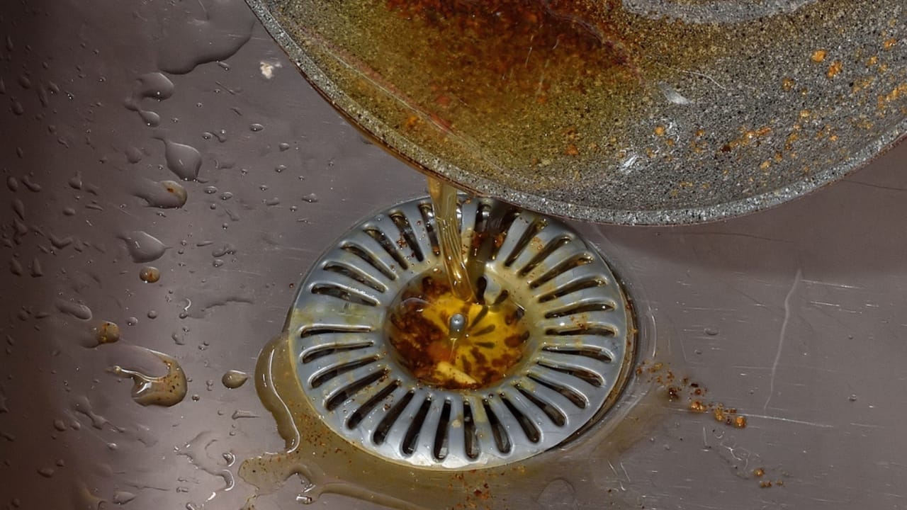 Kitchen Sink Odors? Here’s What’s Causing Them & How to Get Rid of It - oil in sink ss1674452230