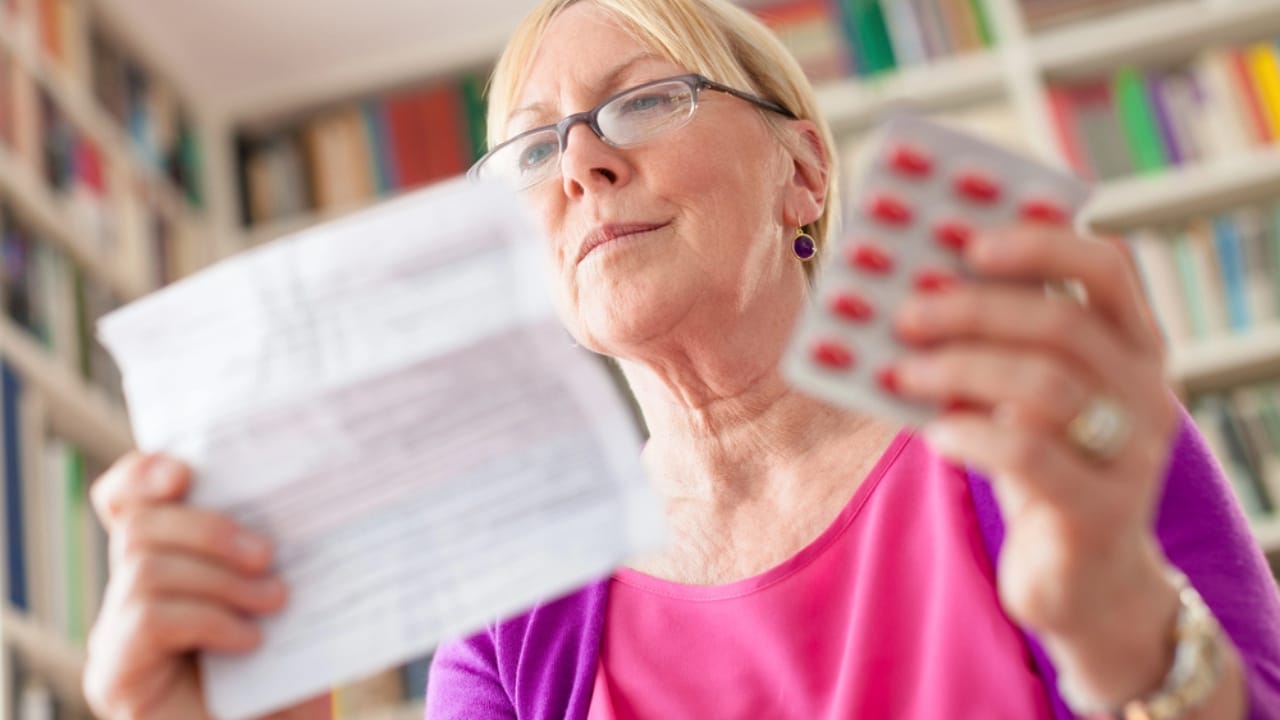 With 51% of Americans Unprepared, Here are 12 Survival Kit Essentials You Might Be Missing 2 With 51% of Americans Unprepared, Here are 12 Survival Kit Essentials You Might Be Missing - old woman reading prescription holding medication dp11085659