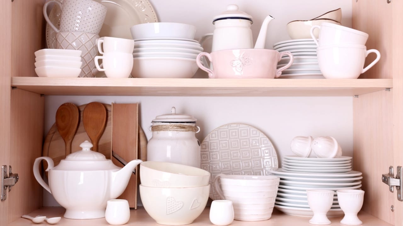 10 Things You Should Never Store in Low Kitchen Cabinets - plate in cabinet dp69479763