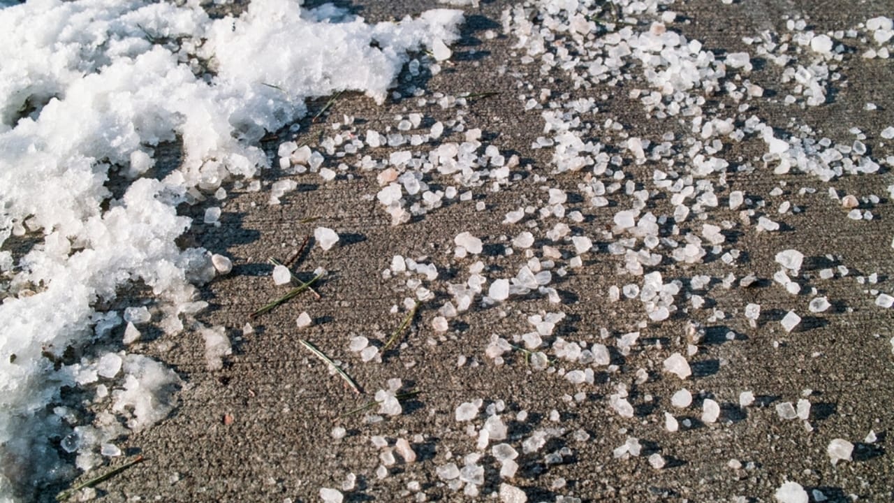 Say Goodbye to Driveway Weeds with These 15 Methods 13 Say Goodbye to Driveway Weeds with These 15 Methods - rock salt on sidewalk ss2367600875