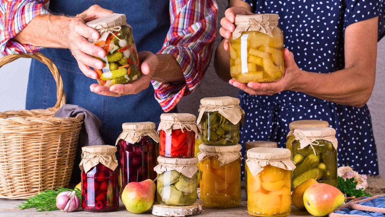 54% of Americans Face Disaster Risks: 18 Goodwill Essentials for Budget Survival Kits - senior couple canning ss1998088235