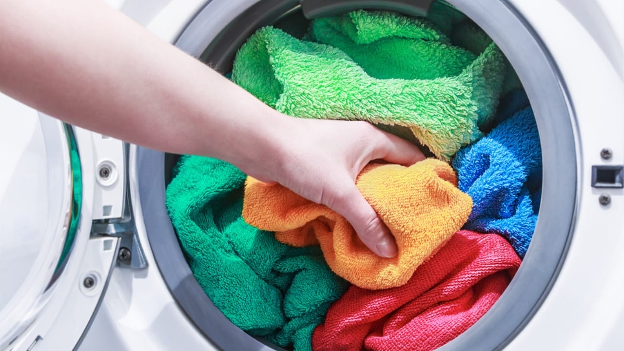 13 Clever Ways to Dry Clothes Indoors Without a Dryer - towel in washing machine ss259943081