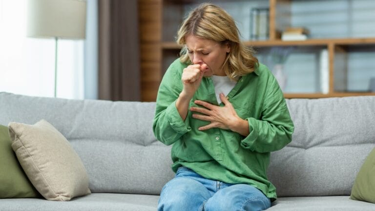 Calm Your Bronchitis Cough with These 12 Simple Home Remedies - woman sick coughing ss2266543099 degm