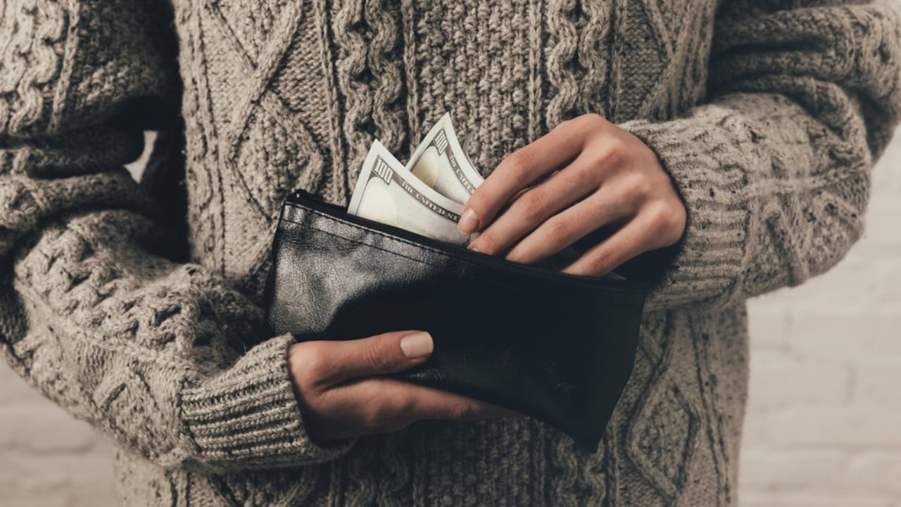 With 51% of Americans Unprepared, Here are 12 Survival Kit Essentials You Might Be Missing 3 With 51% of Americans Unprepared, Here are 12 Survival Kit Essentials You Might Be Missing - woman checking money in wallet dp173645612