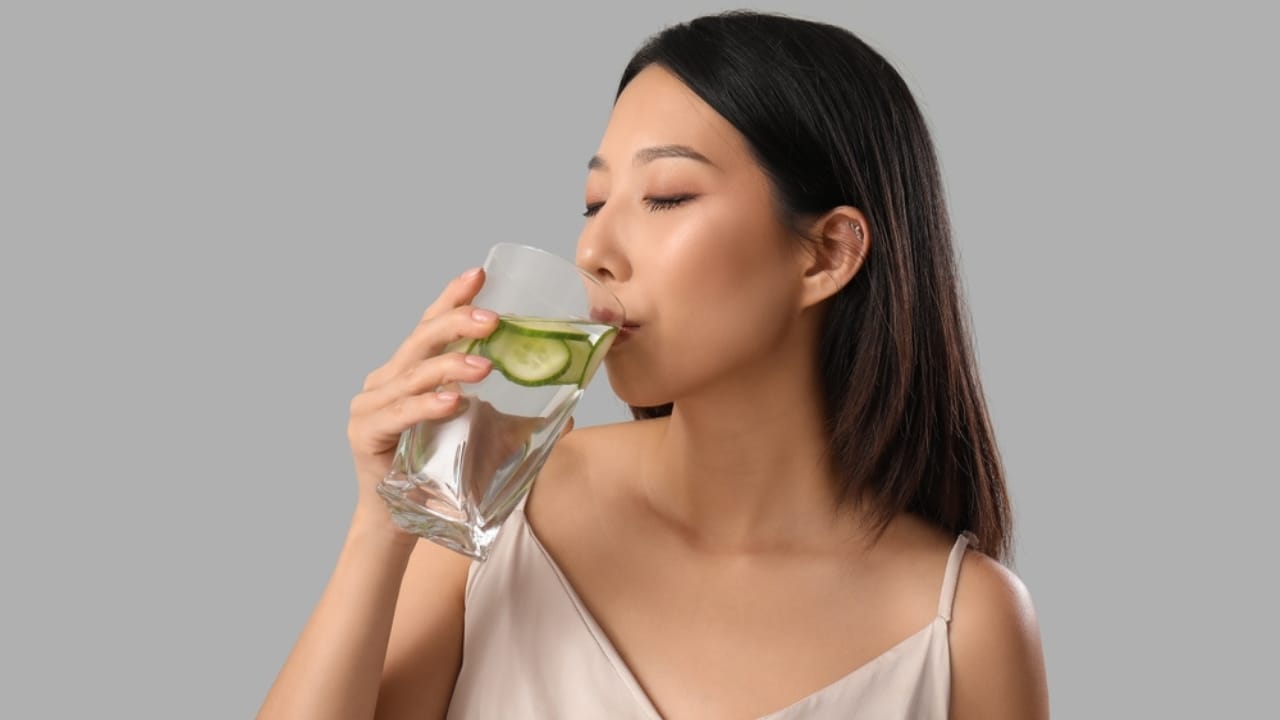 12 Reasons to Add Cucumber Water to Your Wellness Routine 3 12 Reasons to Add Cucumber Water to Your Wellness Routine - woman drinking cucumber water ss2384551927