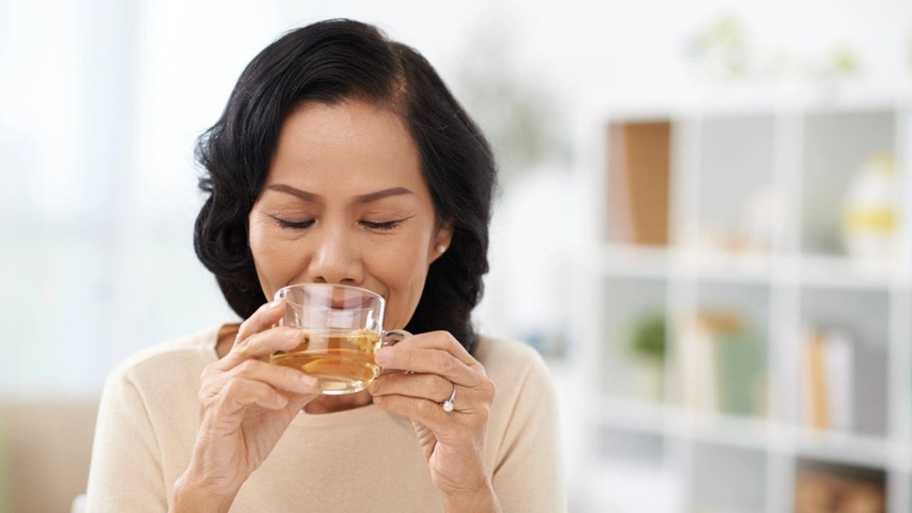 Nature's Perfect Pair: The Hidden Potential of Honey and Cinnamon 7 Nature's Perfect Pair: The Hidden Potential of Honey and Cinnamon - woman drinking tea dp85767500