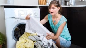 10 Items You’re Probably Washing to Death—and How to Make Them Last Longer 1 10 Items You’re Probably Washing to Death—and How to Make Them Last Longer - woman shocked doing laundry dp85781910