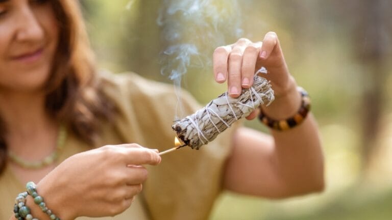 Ancient Ritual Meets Modern Science: Sage Smudging's Impact on Indoor Air Quality - woman smudging sage ss2162731837