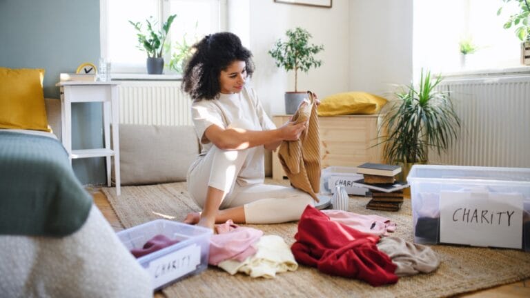 Let the "Didn't Know" Rule Guide Your Purging & Make Decluttering a Breeze - young woman declutter dp452682592
