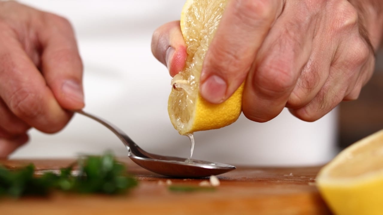 Unlock the Full Potential of Lemons by Freezing Them Whole 6 Unlock the Full Potential of Lemons by Freezing Them Whole - Chef squeezing lemon juice into spoon dp520937950 dnoh