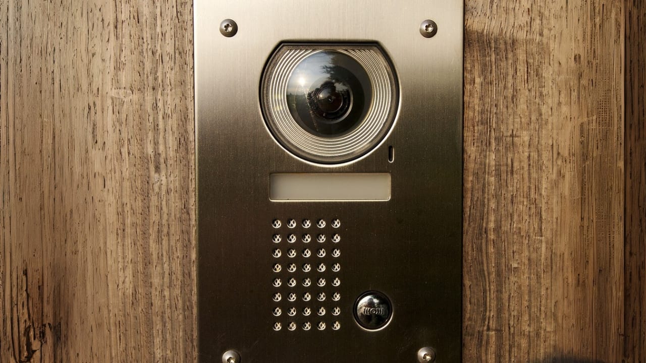 The Dark Side of Smart Doorbells: 14 Dangers You Shouldn’t Ignore 7 The Dark Side of Smart Doorbells: 14 Dangers You Shouldn’t Ignore - Door intercom with camera on wood dp5734672 dnoh