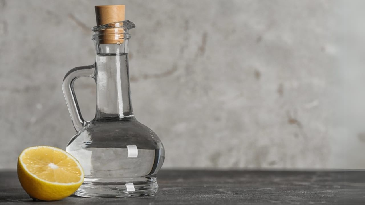 Ditch Chemicals with This Easy DIY Lemon Vinegar Cleaner 2 Ditch Chemicals with This Easy DIY Lemon Vinegar Cleaner - Glass jug with vinegar and lemon on table dp226641320 dnoh