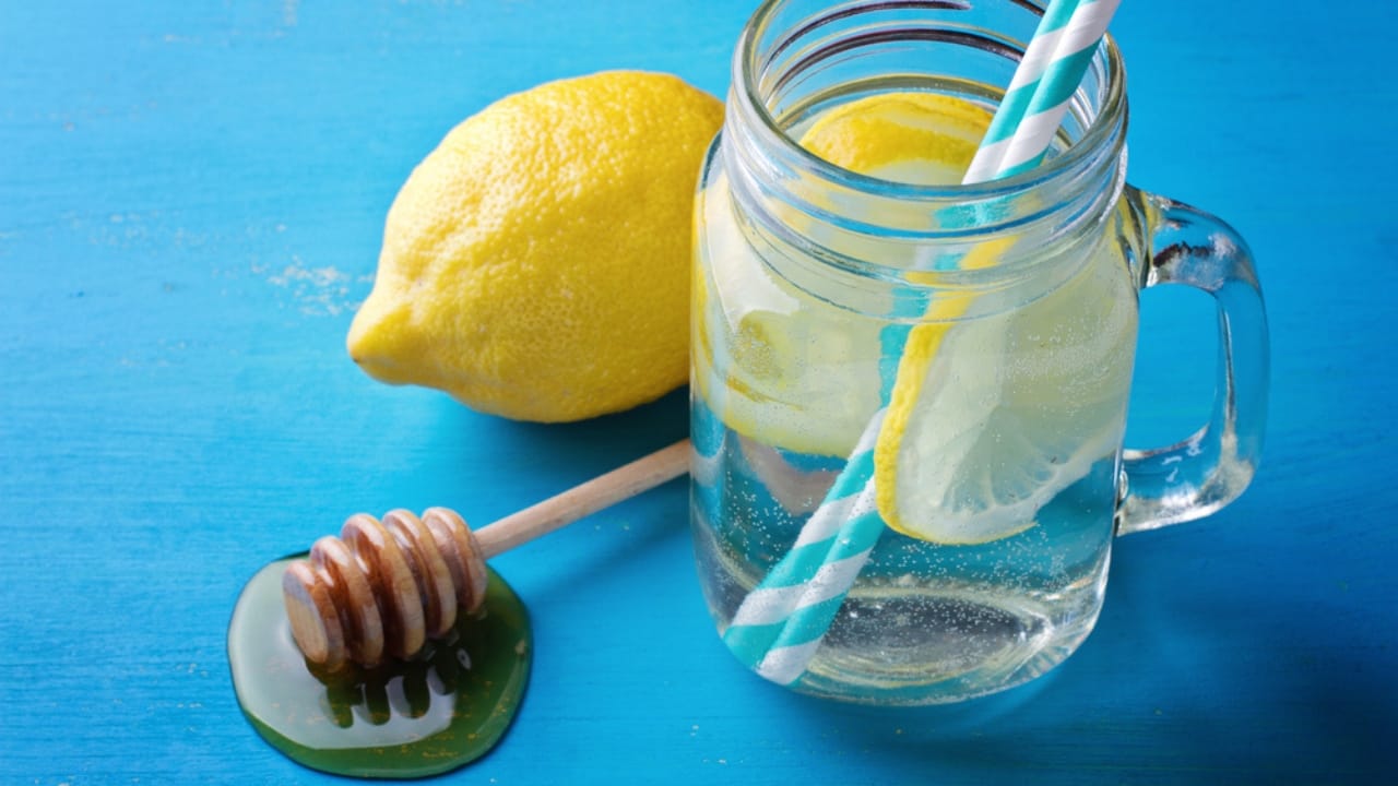 15 Everyday Problems Honey Can Solve Naturally - Jar with water lemon and honey ss433800469 dpdgm