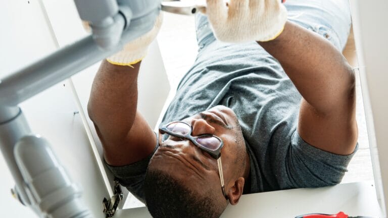 Avoid Costly Repairs: 16 Home Tasks You Shouldn’t Skip 8 Avoid Costly Repairs: 16 Home Tasks You Shouldn’t Skip - Plumber man fixing kitchen sink ss1051746458 degm