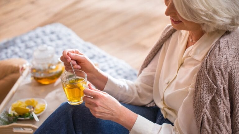 15 Plants Perfect for Starting Your Homegrown Tea Garden - Woman drinking tea dp133955188 dnoh