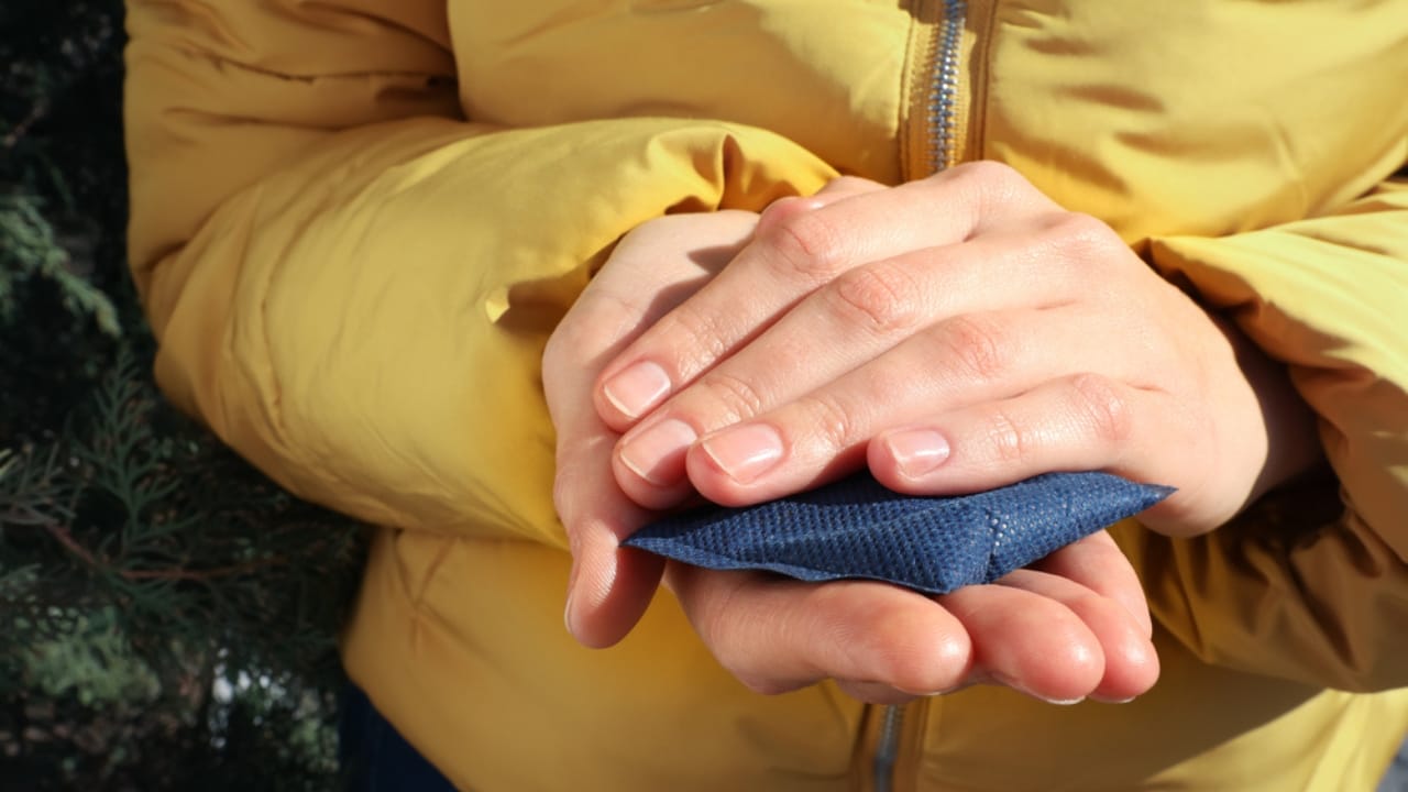 25 Creative DIY Gifts for a Memorable Holiday Season - Woman holding hand warmer outdoors ss1937078686 dpdgm