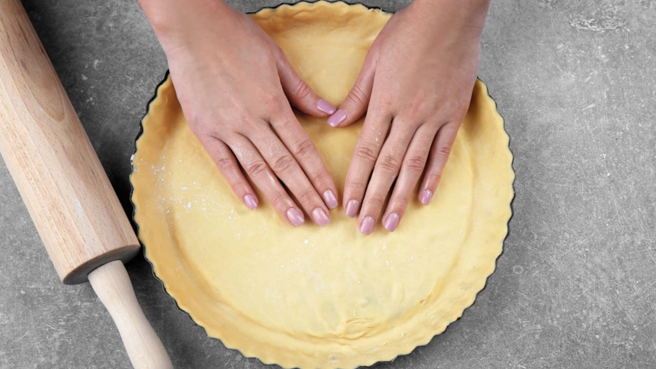 25 Genius Kitchen Tricks for Faster, Cheaper Meals 26 25 Genius Kitchen Tricks for Faster, Cheaper Meals - Woman preparing cake baking dp147106367 dnoh