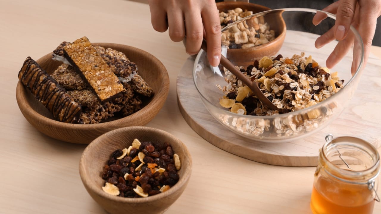 10 No-Bake Granola Bar Recipes to Fit Any Craving - Woman preparing healthy granola bar dp316575838 dnoh