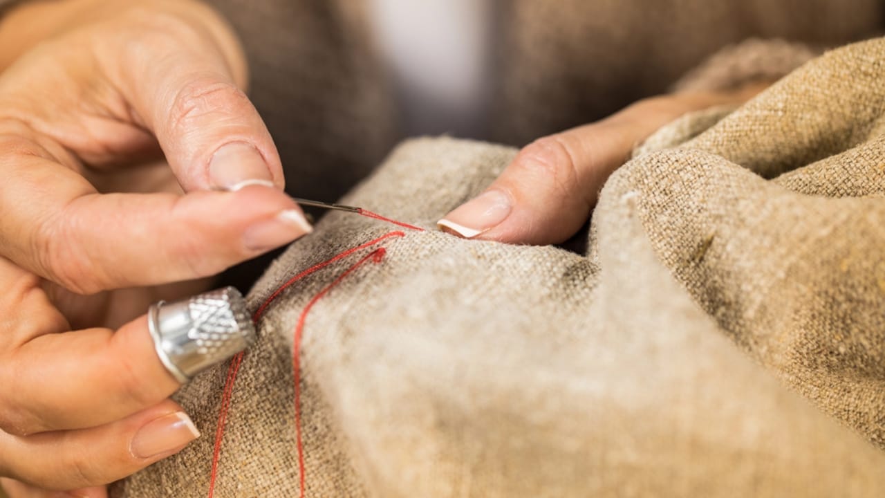 8 Household Chores That Show How Far We've Come 8 8 Household Chores That Show How Far We've Come - Woman sewing cloth dp135569624 dnoh