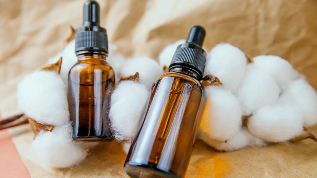Make Your Bathroom Smell Amazing with This Cotton Ball Hack 7 Make Your Bathroom Smell Amazing with This Cotton Ball Hack - bottle of essential oil cotton flowers dp506962856 dnoh