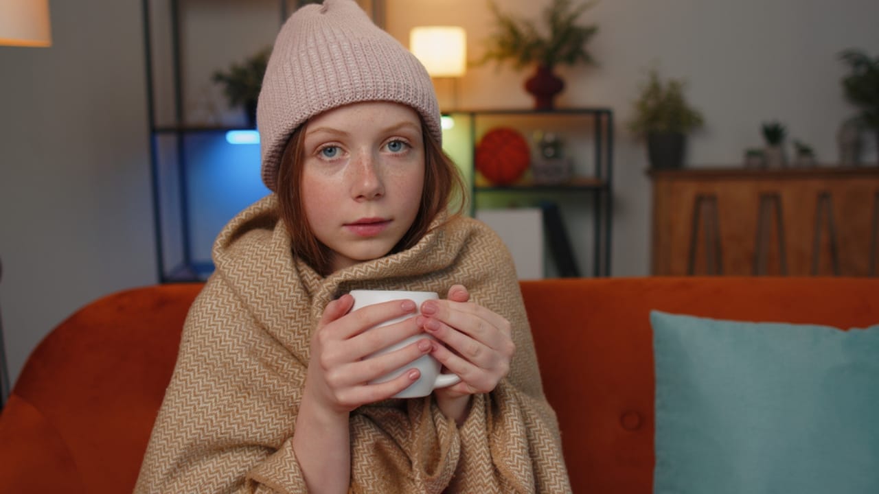 13 Ways to Stay Warm Without Cranking the Heat 10 13 Ways to Stay Warm Without Cranking the Heat - girl wearing hat indoor dp593885822 dnoh