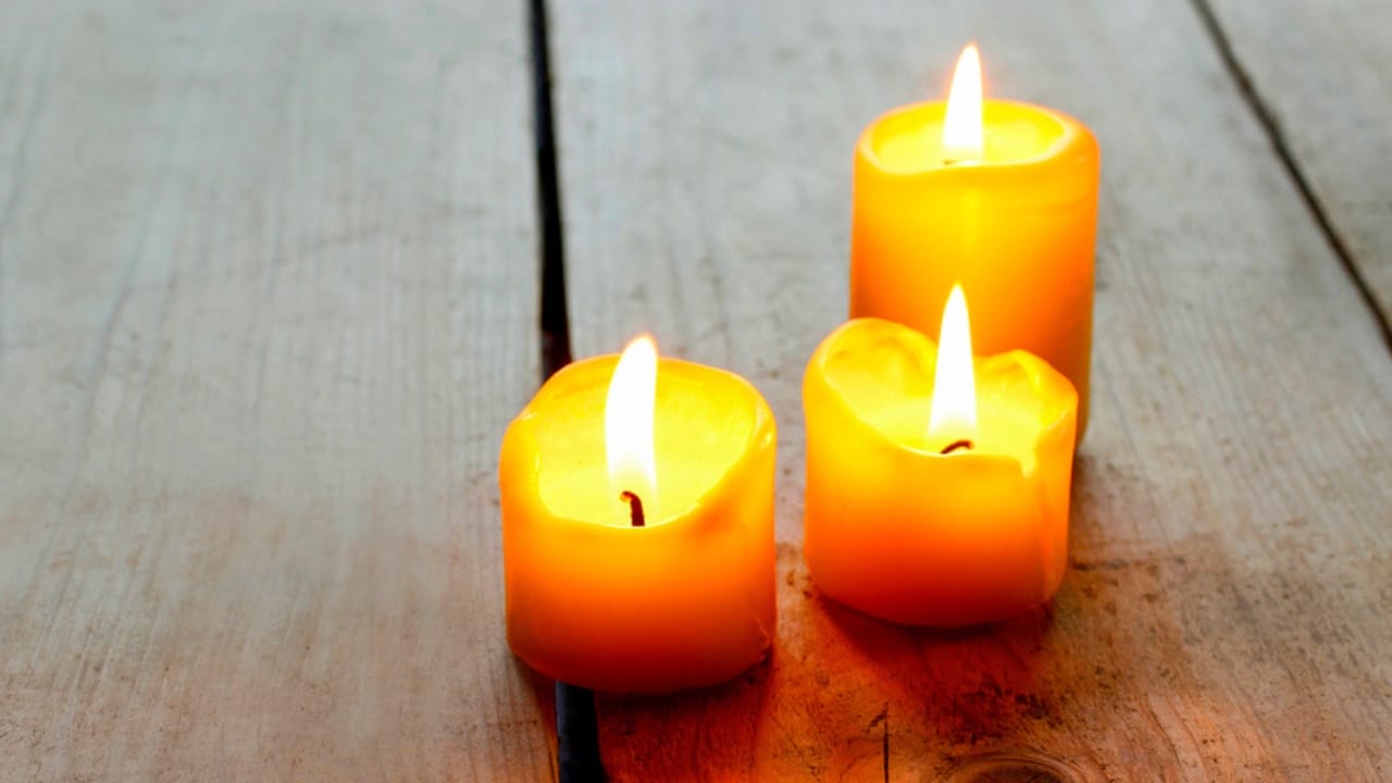 You’re Probably Burning Candles Wrong—Here’s How to Fix It 8 You’re Probably Burning Candles Wrong—Here’s How to Fix It - golden candles on wooden table dp72853949 dnoh