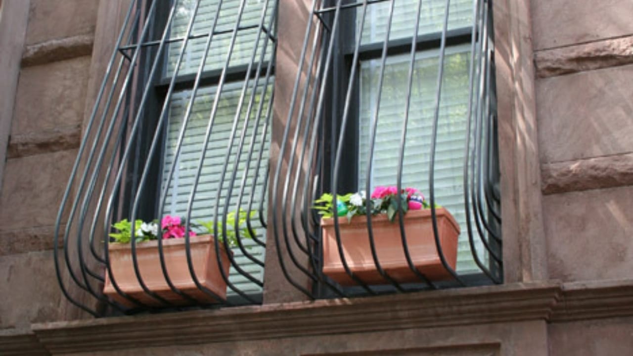 Why Some Window Bars Curve: The Secret Behind the Design 3 Why Some Window Bars Curve: The Secret Behind the Design - grill with flowers