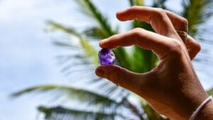 This Gemstone, Rarer Than Diamonds, Was Found by Accident 1 This Gemstone, Rarer Than Diamonds, Was Found by Accident - hand of a woman holding purple gemstone ss2425512921 adyh