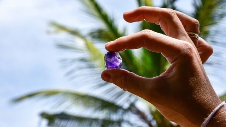 This Gemstone, Rarer Than Diamonds, Was Found by Accident 8 This Gemstone, Rarer Than Diamonds, Was Found by Accident - hand of a woman holding purple gemstone ss2425512921 adyh