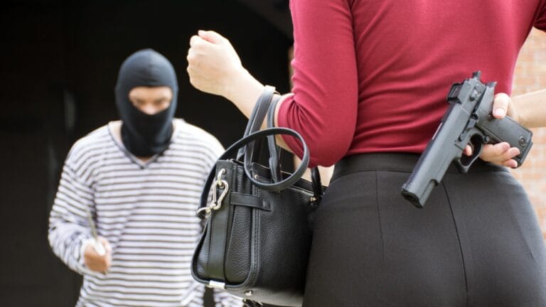 10 Reliable Firearms for Preppers: Covering Defense & Survival - male robber with woman ss723834073 adyh