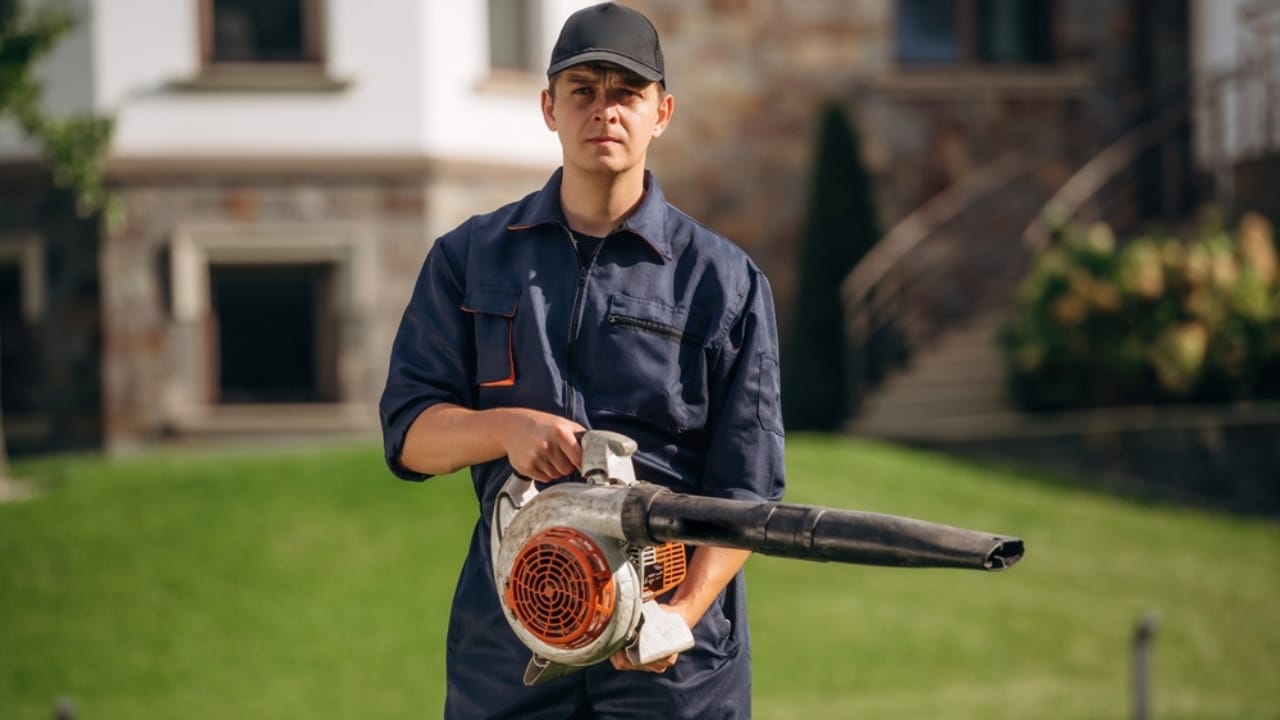 12 Leaf Blower Hacks That Will Change How You Use It Year-Round - man using leaf blower ss2534024239 adyh
