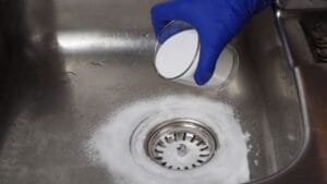 Clog-Free Pipes Made Easy with This Baking Soda Routine 1 Clog-Free Pipes Made Easy with This Baking Soda Routine - pouring baking soda on drain kitchen sink ss2225119433 adyh