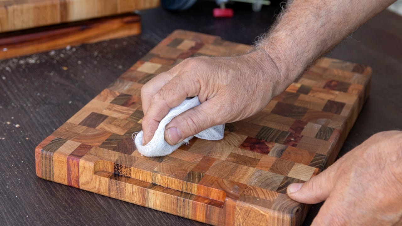 15 Natural Cleaning Recipes That Rival Chemical Products - wiping wooden cutting board dp475830194 dnoh