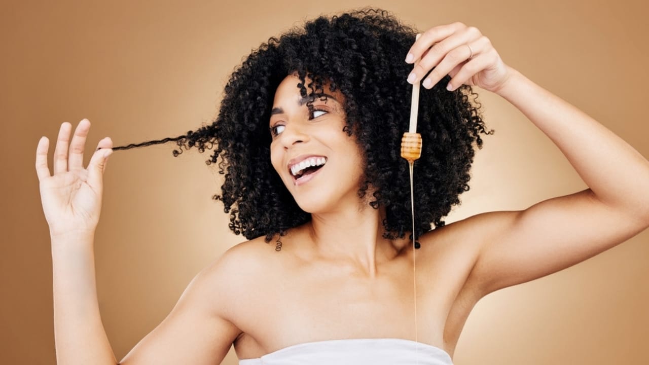15 Everyday Problems Honey Can Solve Naturally 4 15 Everyday Problems Honey Can Solve Naturally - woman applying honey in her hair ss2372612493 dpdgm