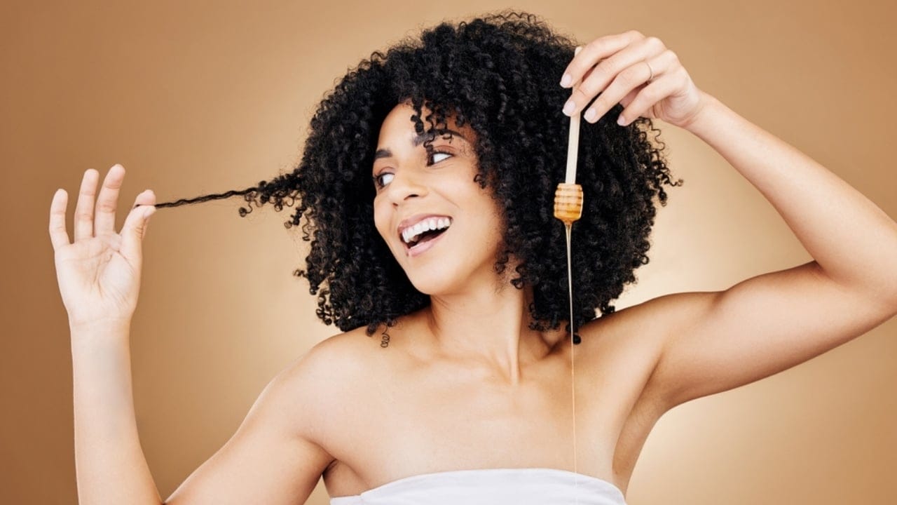 15 Everyday Problems Honey Can Solve Naturally - woman applying honey in her hair ss2372612493 dpdgm